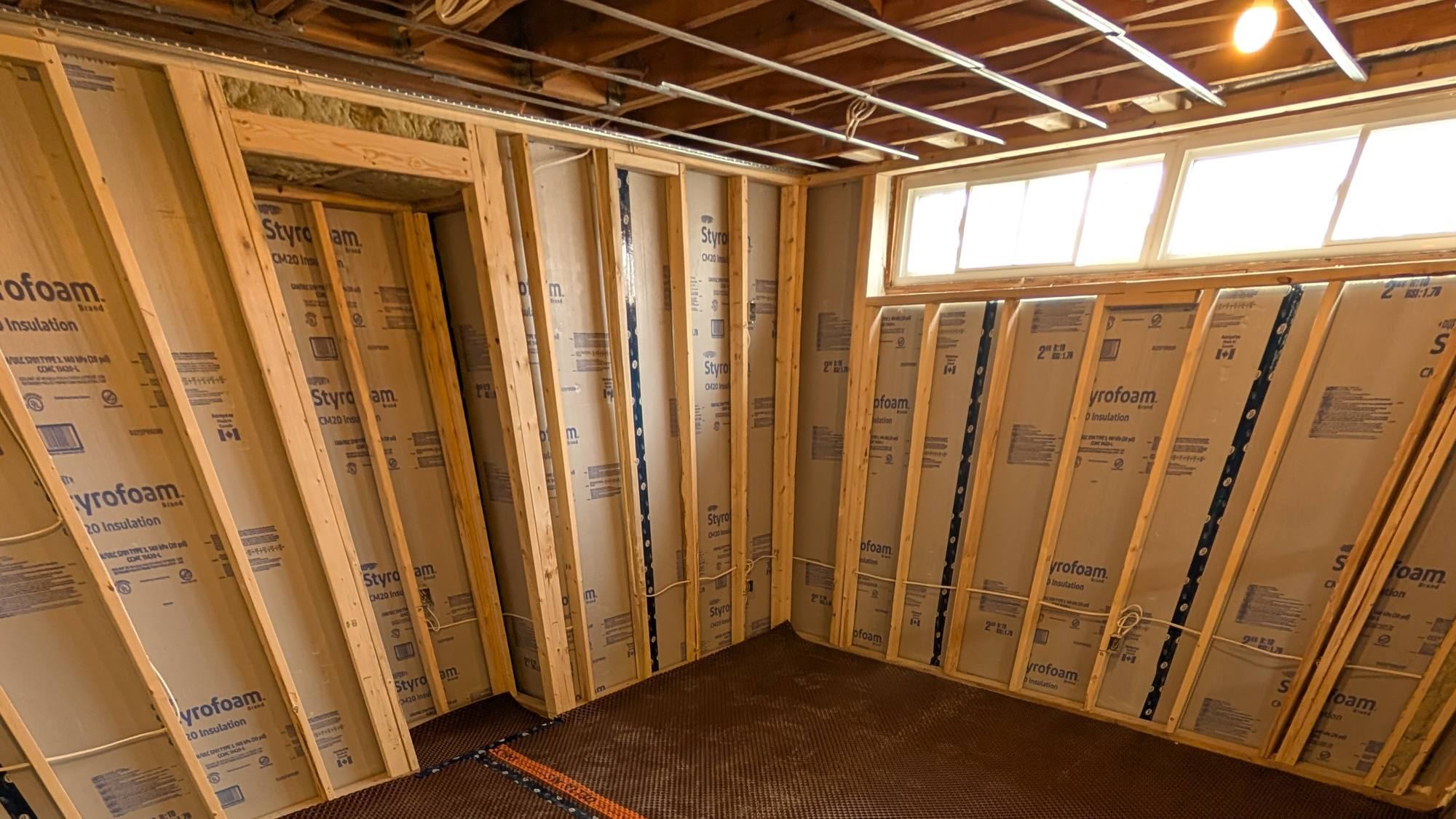 Basement framing with insulation and dimple membrane subfloor