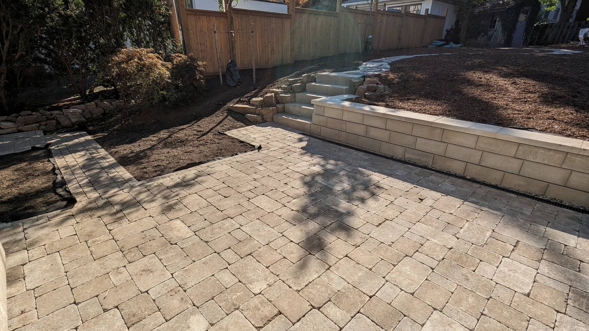 Paver patio with retaining wall and stone steps